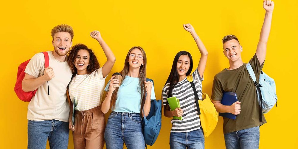 Group of happy students on color background